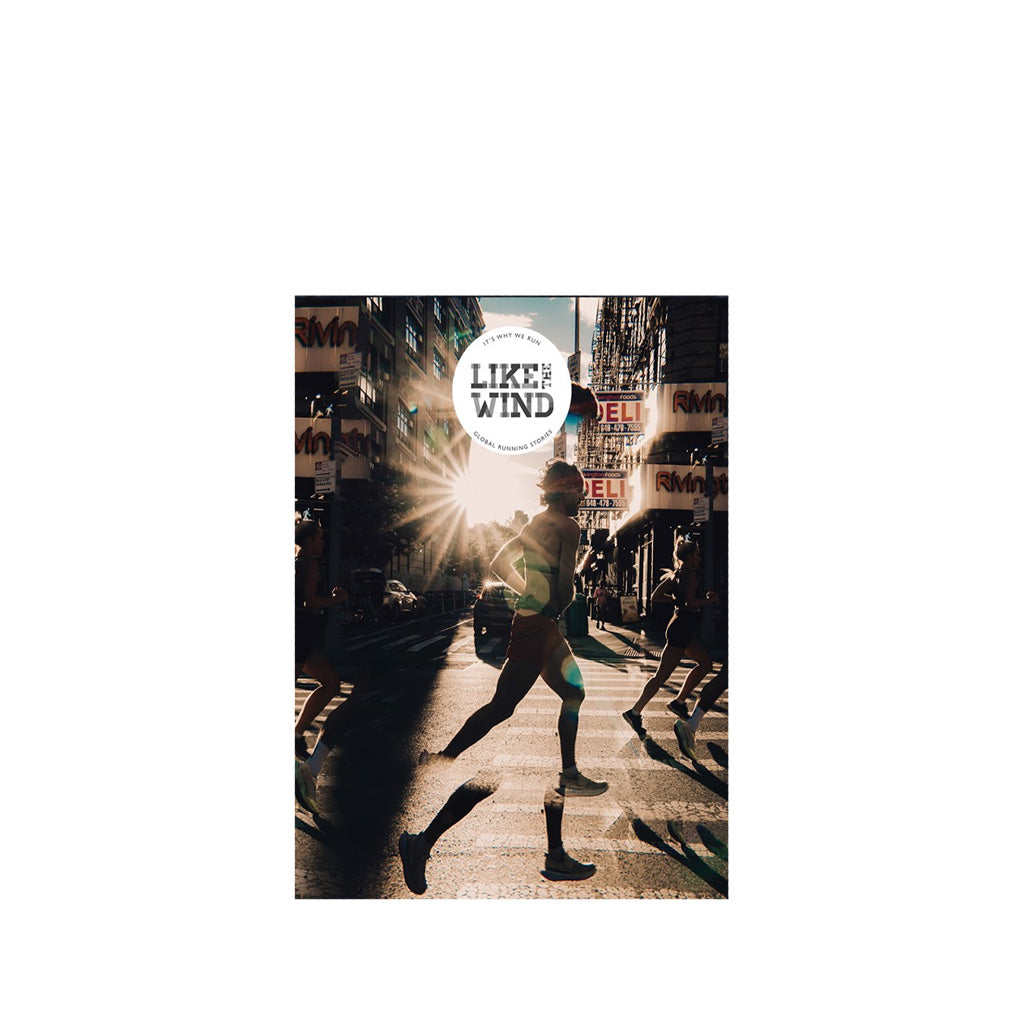 Like the Wind magazine cover with a person running on a city street with sun glare