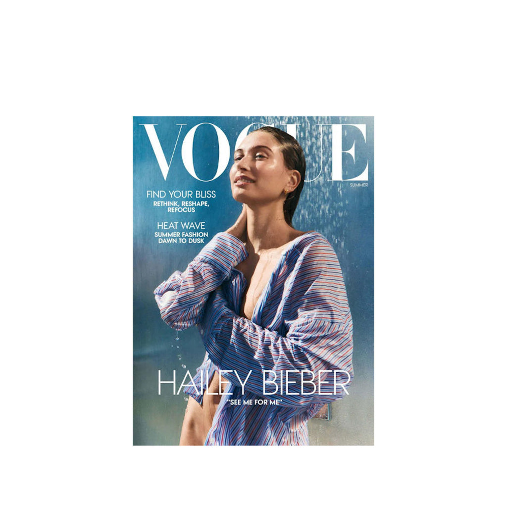 Vogue magazine cover featuring Hailey Bieber with a blue and white striped dress.